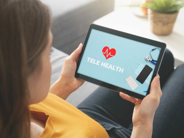 Telemedizin erleichtert den Zugang zu medizinischem Cannabis. Eine Frau schaut auf ihr Tablet und checkt die Telemedizin aus.